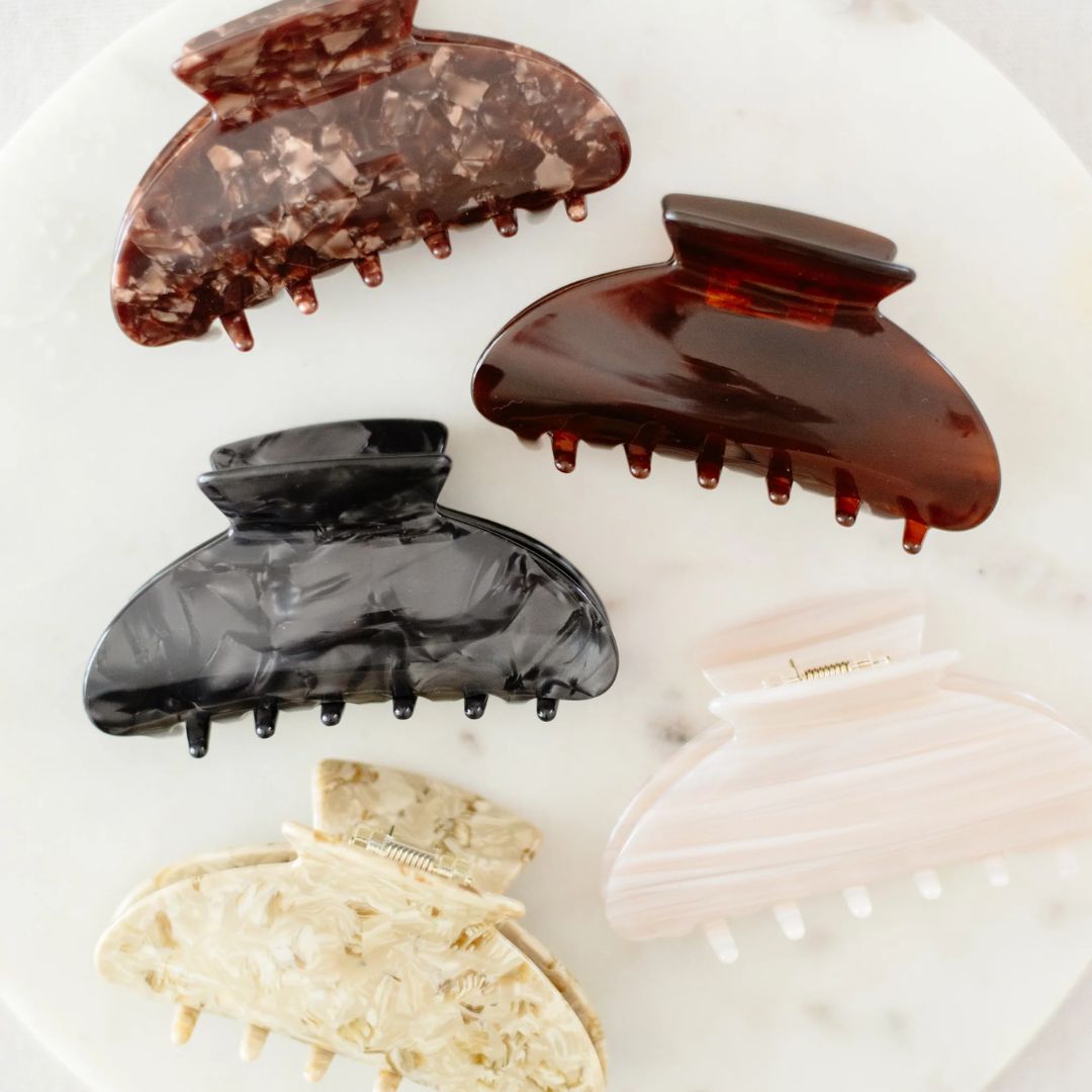 Set of various hair clips on a white surface