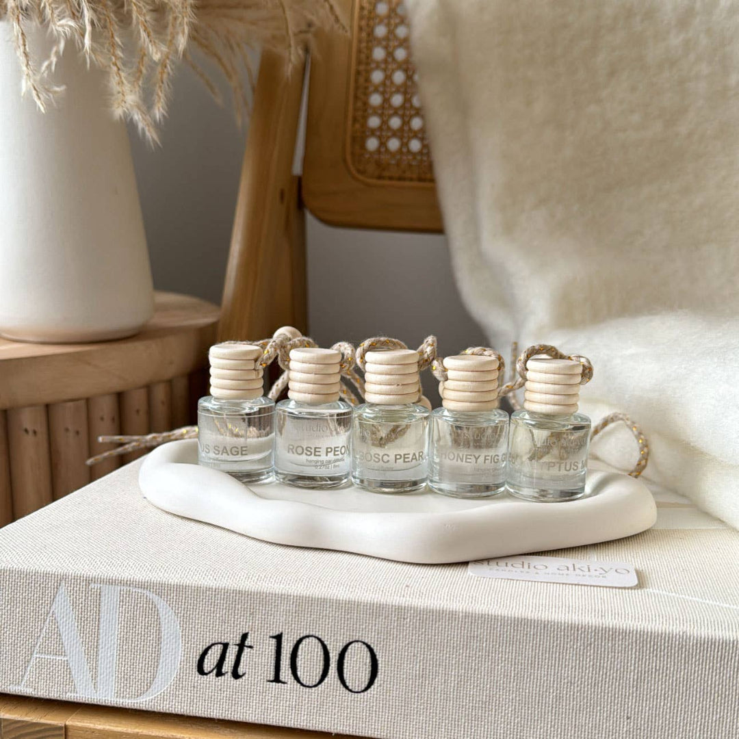 Set of small glass bottles with wooden caps on a decorative tray