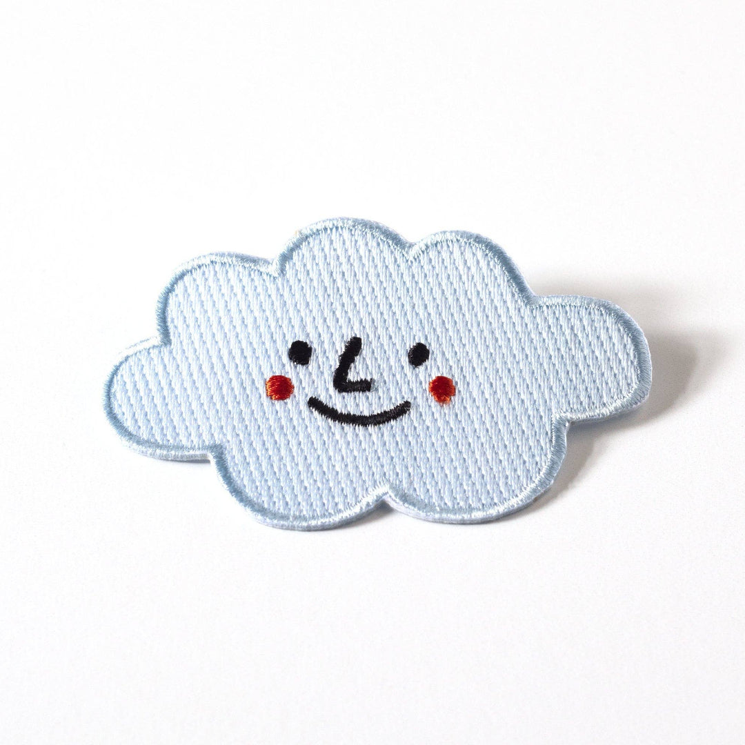 Smiley face cloud patch on a white background