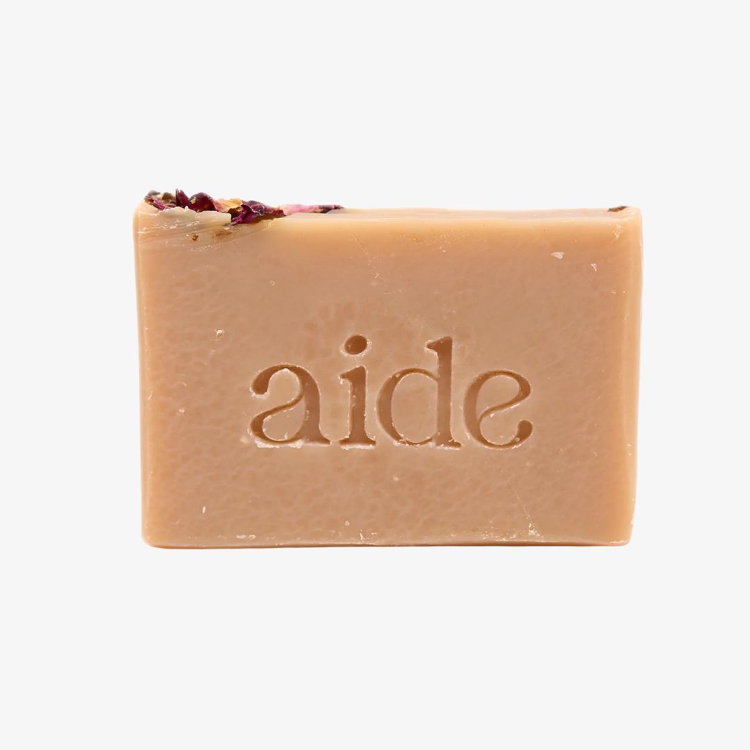 Bar of soap with 'aide' branding on a light gray background
