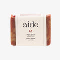 Bar of soap with 'aide' branding on a white background