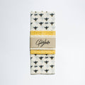 Packaged Goldylocks kitchen towel with bee and honeycomb pattern on a white background