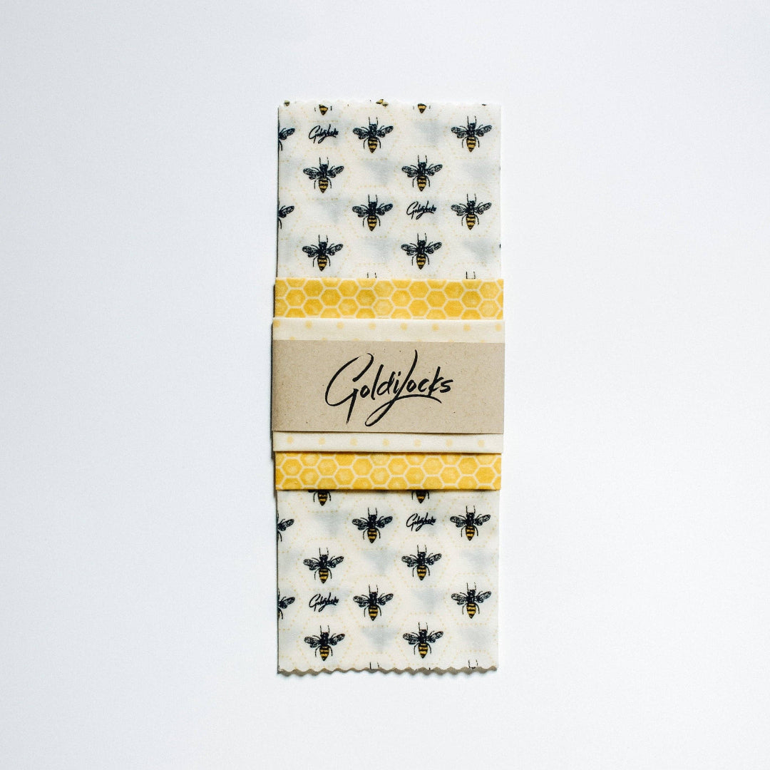 Packaged Goldylocks kitchen towel with bee and honeycomb pattern on a white background