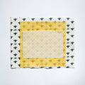 Fabric square with bee pattern border on a white background