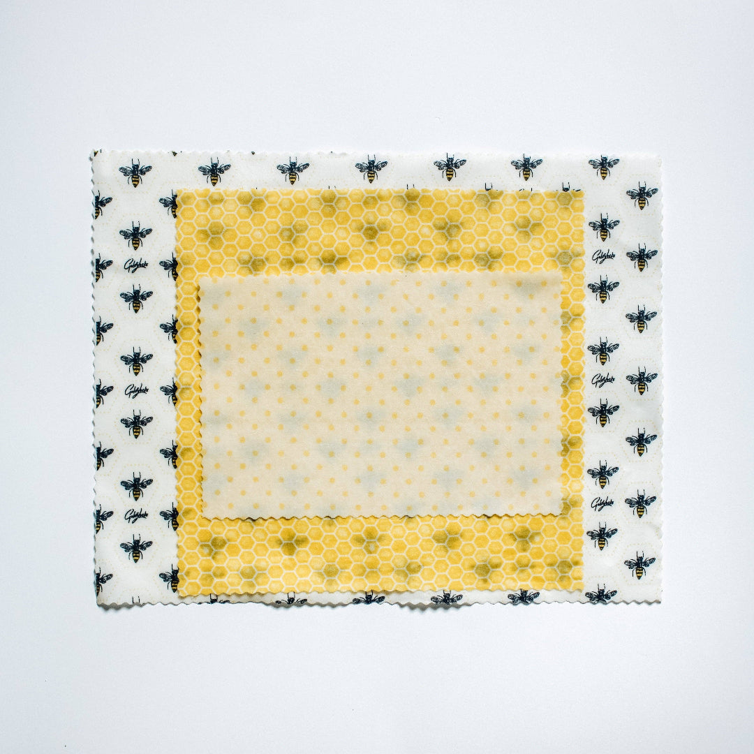 Fabric square with bee pattern border on a white background