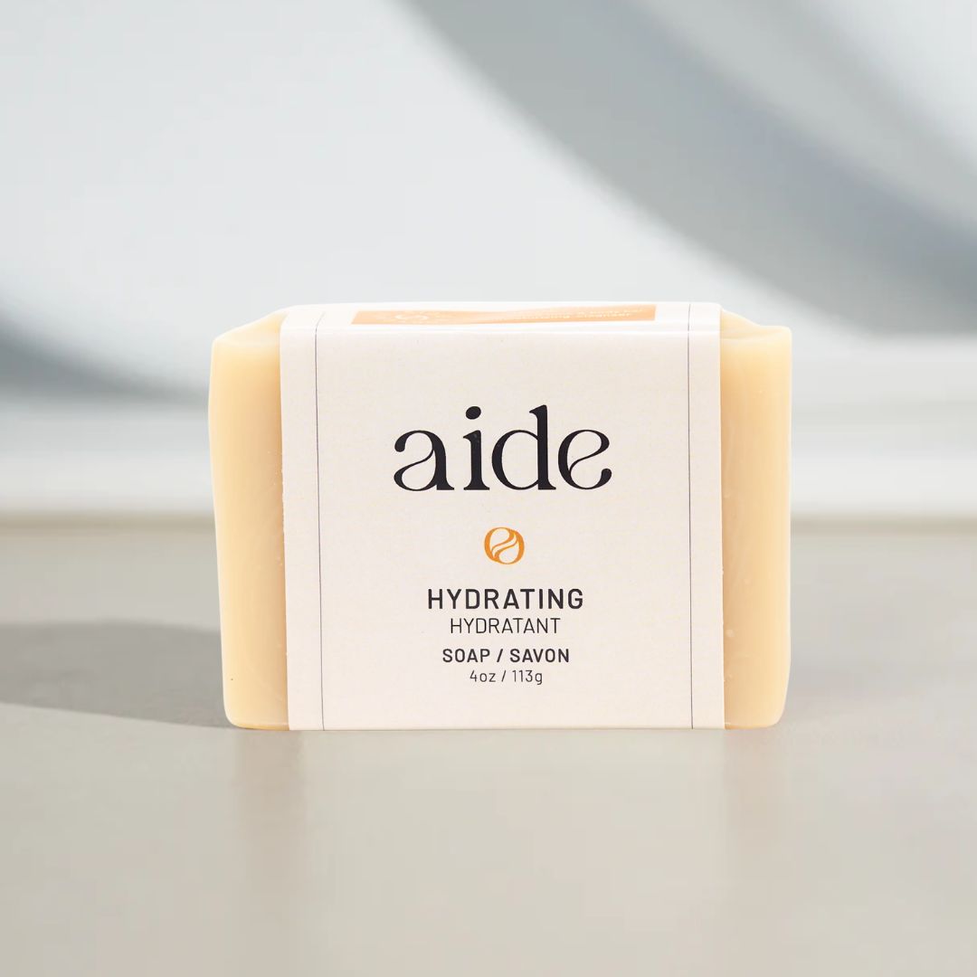 Bar of soap with 'aide' branding on a neutral background