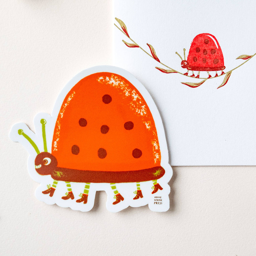 Sticker of a red ladybug with orange spots on a white background
