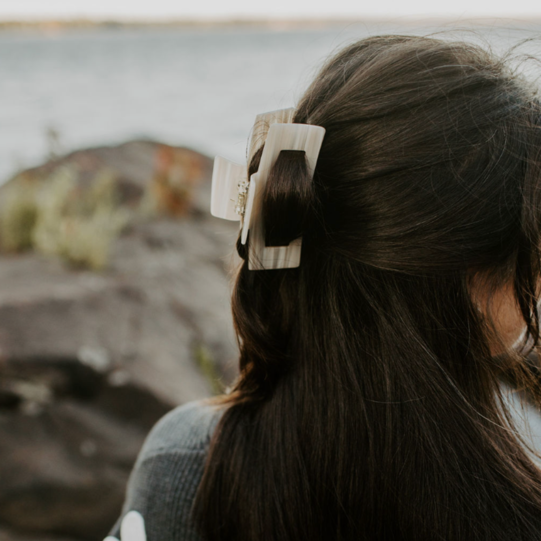 Person with a hair clip by a body of water