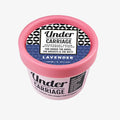 Deodorant cream container with pink lid and black and white label on a white background