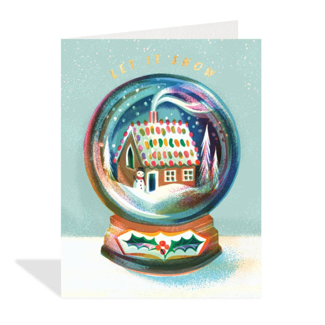Greeting card with a snow globe design featuring a house and 'Let it Snow' text on a light blue background.