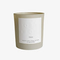 A beige candle with a white label, titled 'Linen', encased in a clear glass jar.