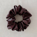 Brown scrunchie on a light gray background