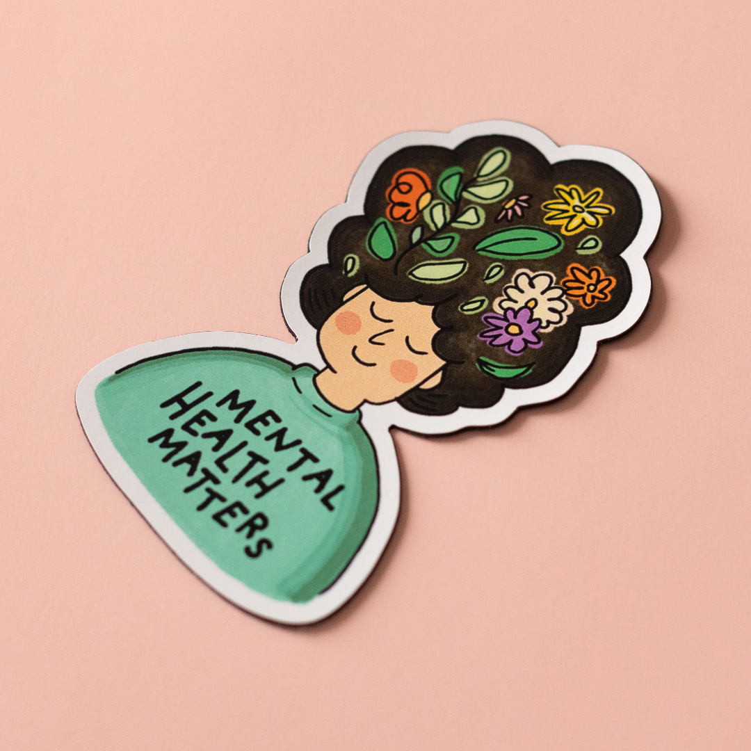 Mental Health Matters vinyl sticker is an illustration of a person with flowers in their big hair and the words "MENTAL HEALTH MATTERS" on their shirt.