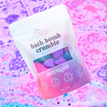 Bath bomb crumble packaging with 'mermaid' theme on a colorful, textured background