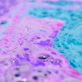 Close-up of colorful, textured surface with pink and blue hues