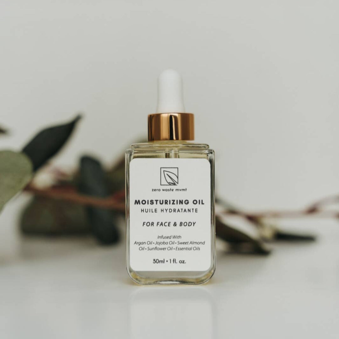 Bottle of moisturizing oil with a white label on a light background