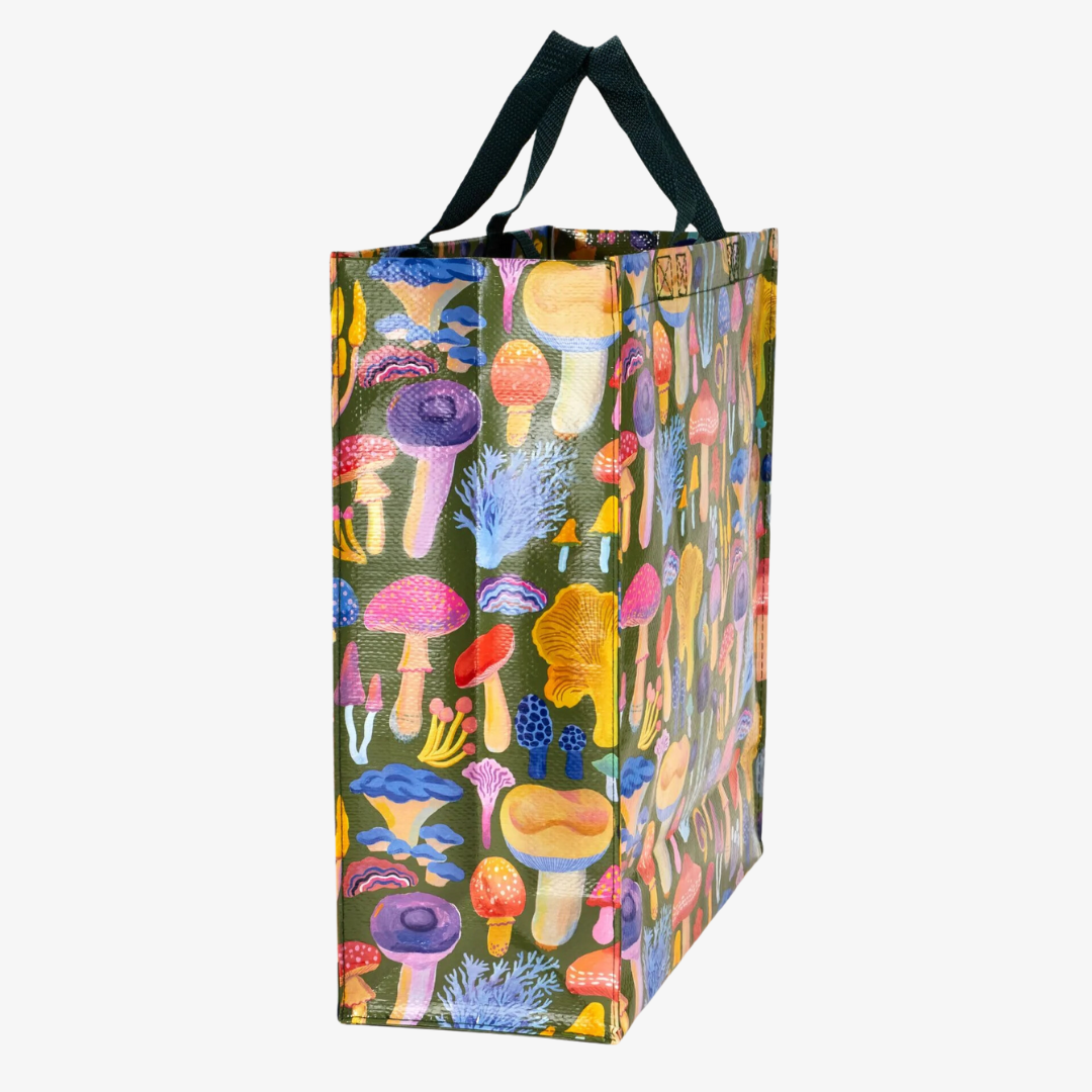 A reusable tote bag with a mushroom pattern. The bag is olive green with black handles. It is covered in a variety of colorful mushrooms in different shapes and sizes.