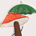 Illustration of a brown creature holding a green umbrella over a red mushroom with black spots on a white background
