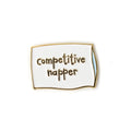 Enamel pin with 'competitive happer' text on a white background