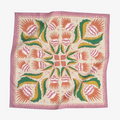 A pink bandana with a floral pattern. The pattern features pink and orange flowers with green leaves on a cream background. The border of the bandana is pink with a decorative pattern.