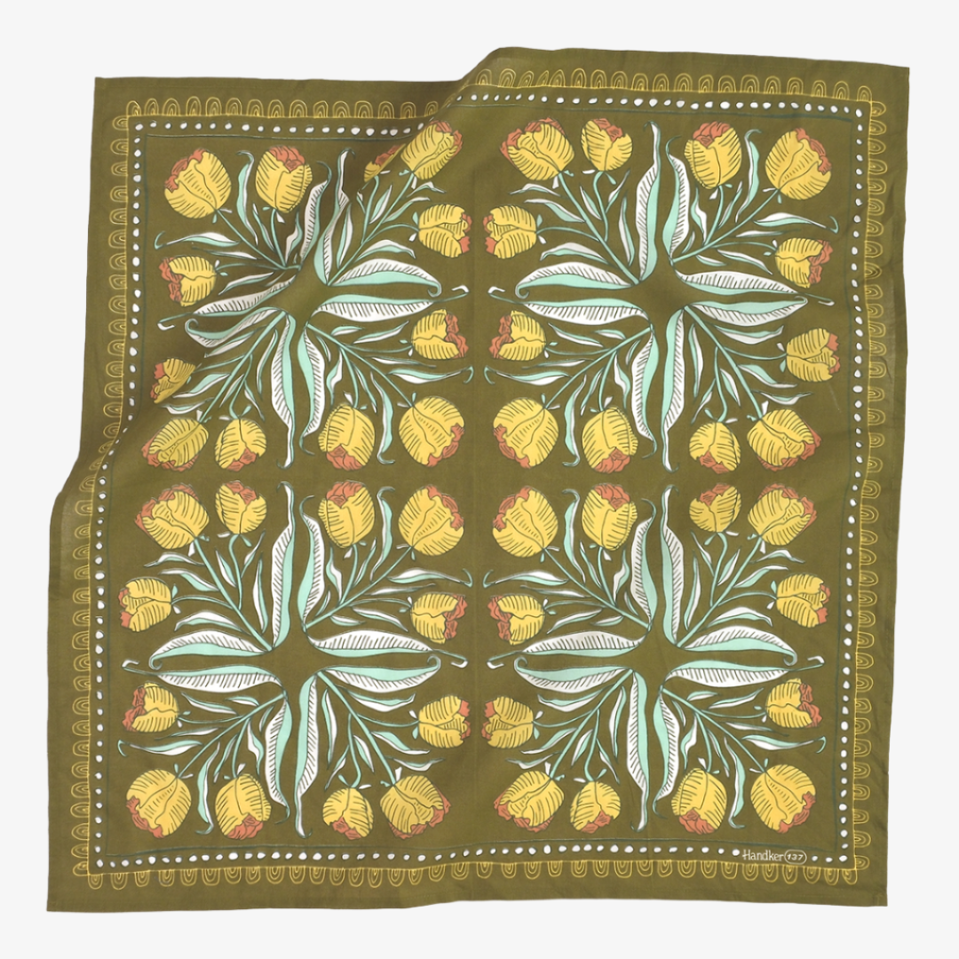 Floral patterned fabric with yellow flowers and green leaves on a brown background