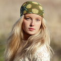 Woman wearing a patterned headband with a blurred natural background