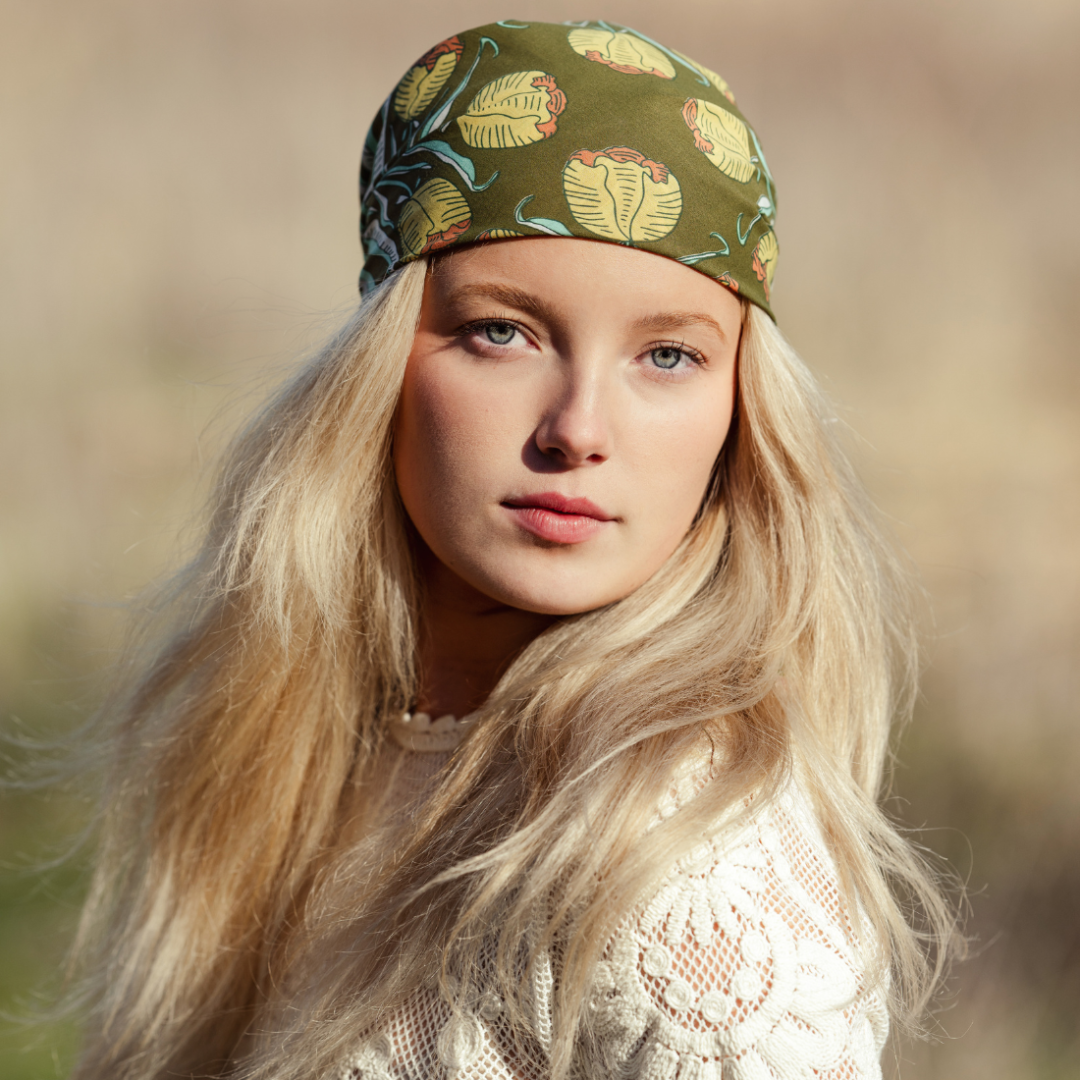 Woman wearing a patterned headband with a blurred natural background