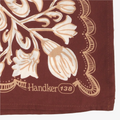 Close-up of a brown fabric with beige floral patterns and 'Handker 138' branding.