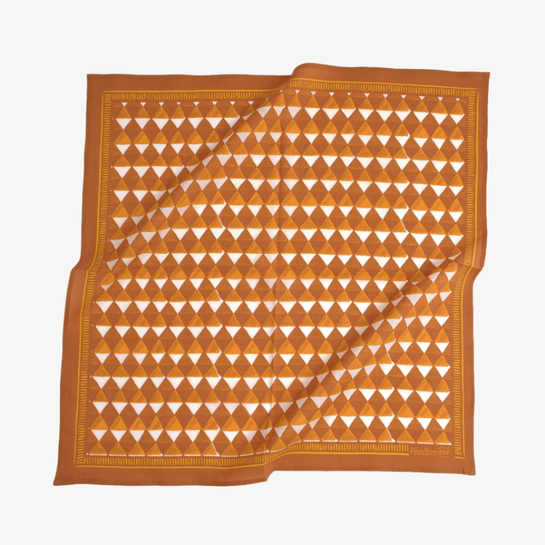 Orange and white patterned fabric on a white background