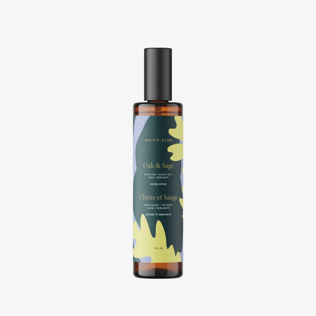 Bottle of Oak & Sage room spray with floral design on a white background