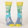 pair of men's crew socks with a vibrant stripe pattern. One sock features wide horizontal green and blue stripes, while the other has blue and white stripes on the foot and green and white stripes on the calf. Text on the socks reads "I'LL TAKE: one order of woods two large lakes and a jumbo mountain."