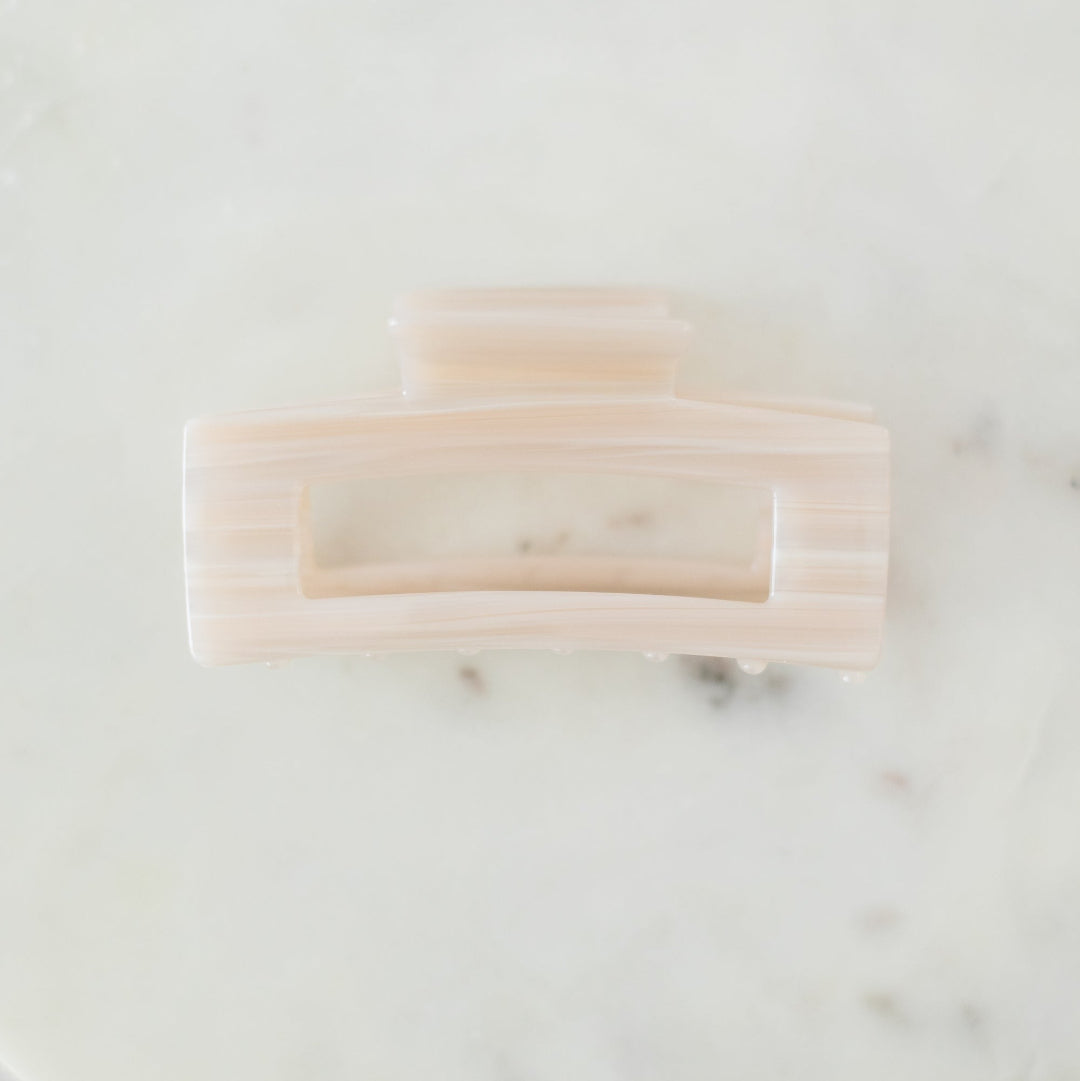 Two soap bars on a marble surface