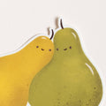 Two cartoon pears with smiling faces on a white background