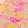 Colorful swirling pattern with pink, yellow, and orange hues on a textured surface.