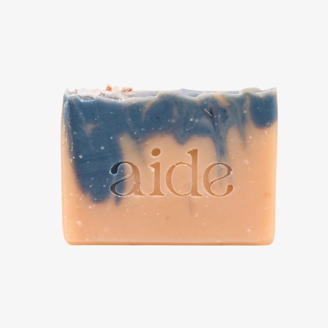 Bar of soap with 'aide' branding on a white background