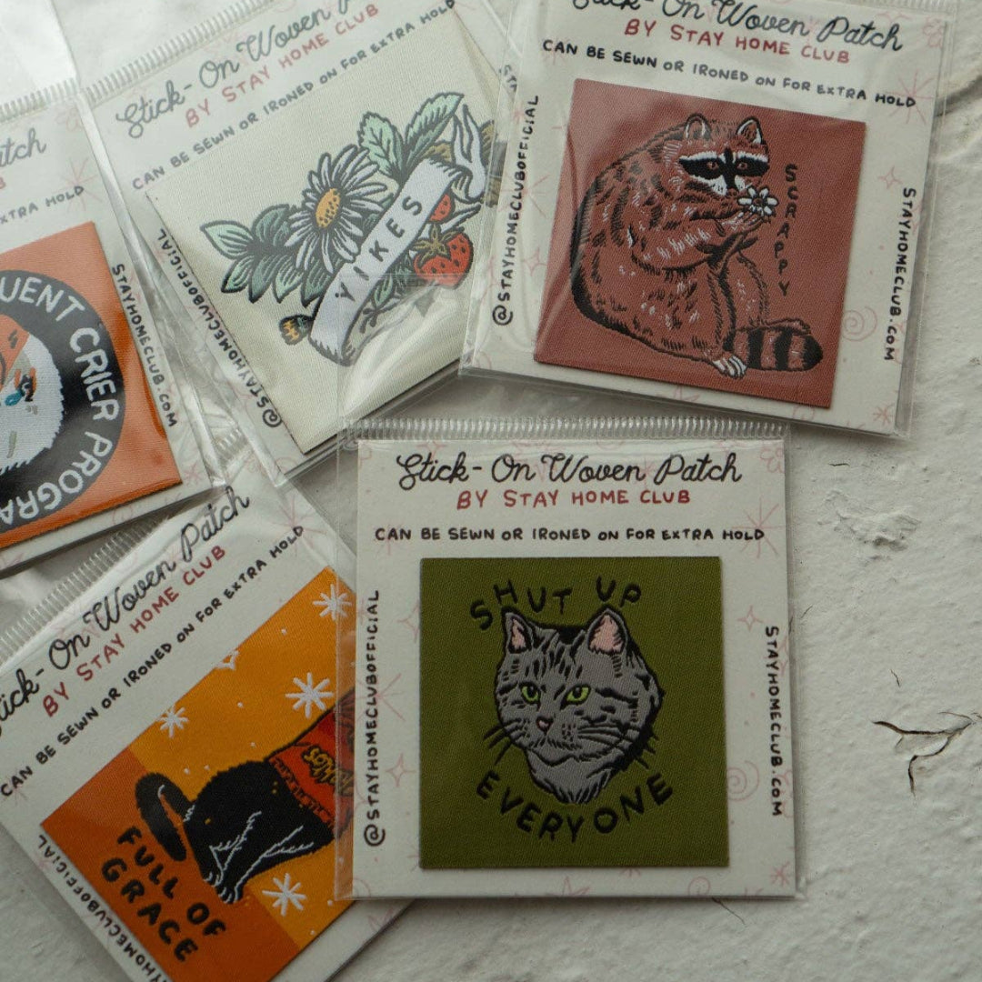Collection of woven patches with various designs on a textured surface