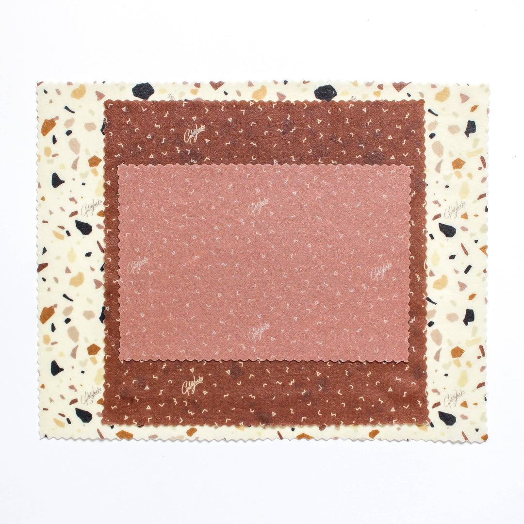 Fabric swatches with different patterns on a terrazzo border