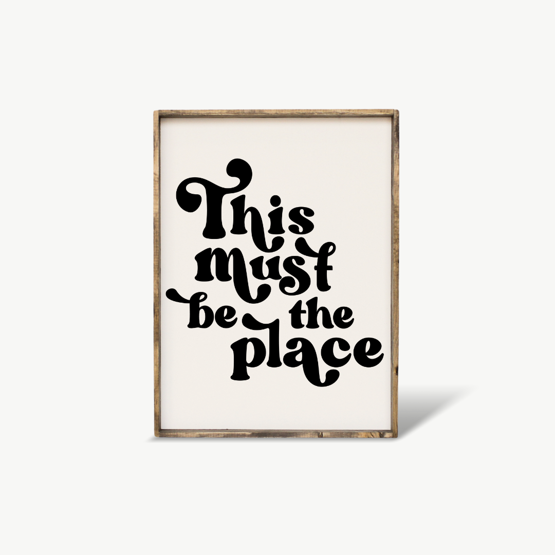 Framed print with 'This must be the place' text on a white background