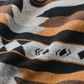 The Thunderbird Reversible Eco-Friendly Blanket by Mini Tipi, featuring bold Indigenous-inspired Thunderbird and geometric patterns in black, grey, and brown. This sustainable and culturally significant blanket is available in Ottawa, Ontario, Canada.