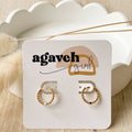Gold hoop earrings on a 'agaveh girl' branded card with a scalloped white dish in the background.