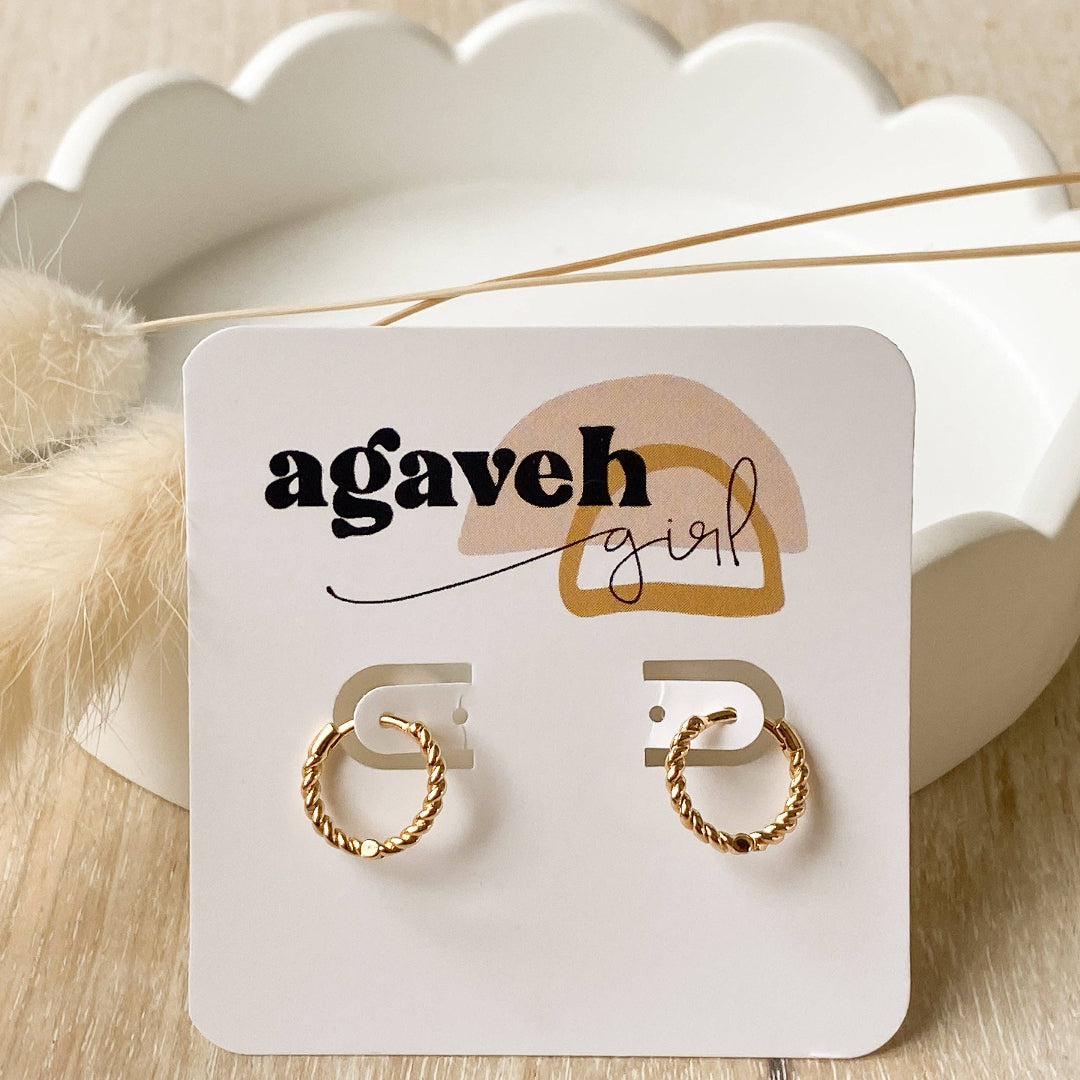 Gold hoop earrings on a 'agaveh girl' branded card with a scalloped white dish in the background.