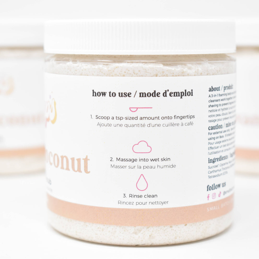 Jar of coconut bath salts with usage instructions on a white background