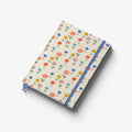 Notebook with floral pattern and blue strap on a white background