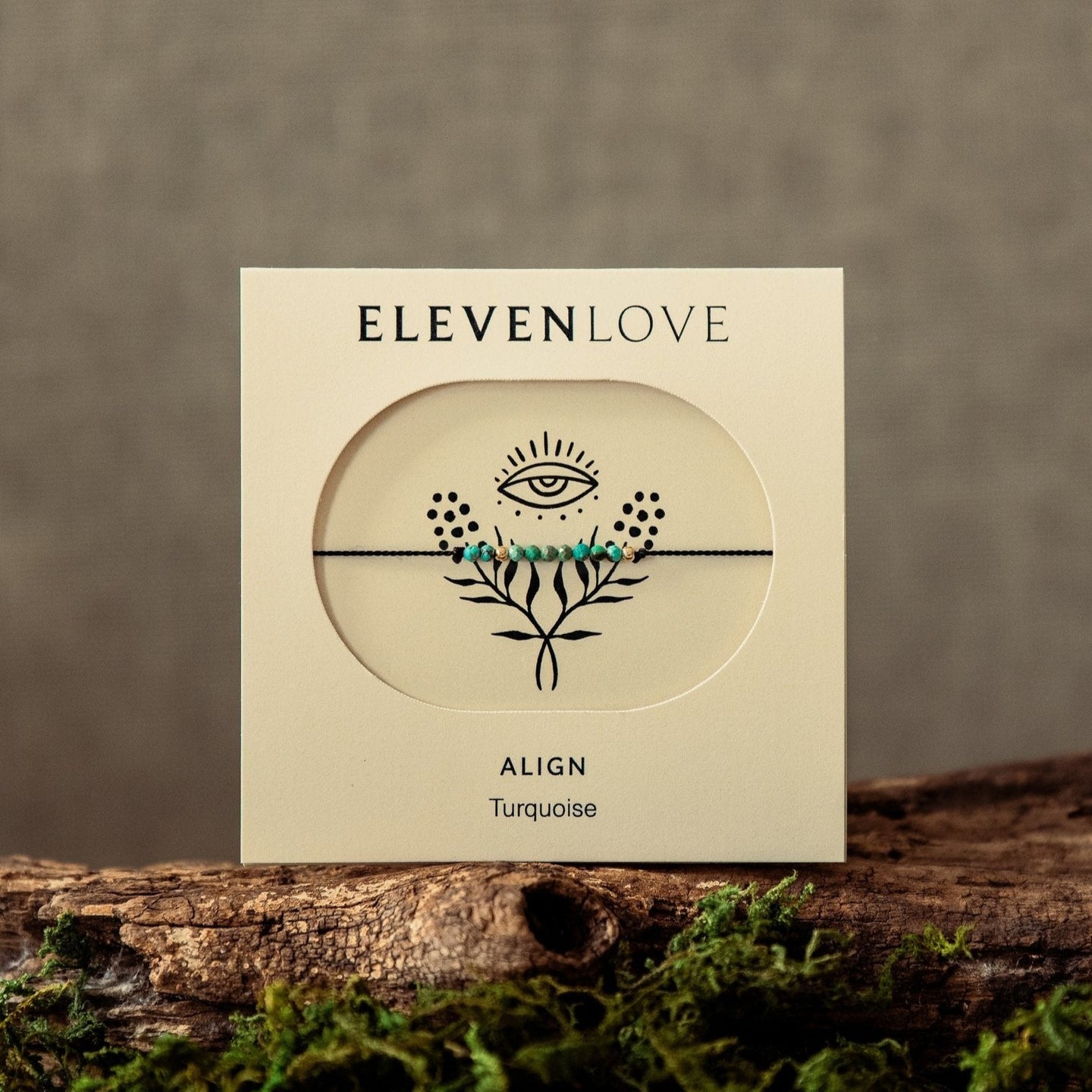 Product packaging for 'Eleven Love Align Turquoise' on a wooden surface with a natural background