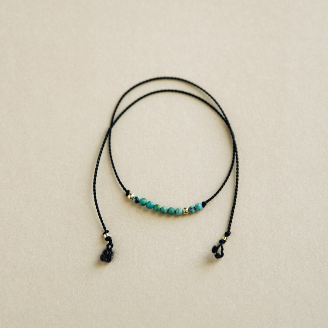 Bracelet with turquoise beads on a beige background