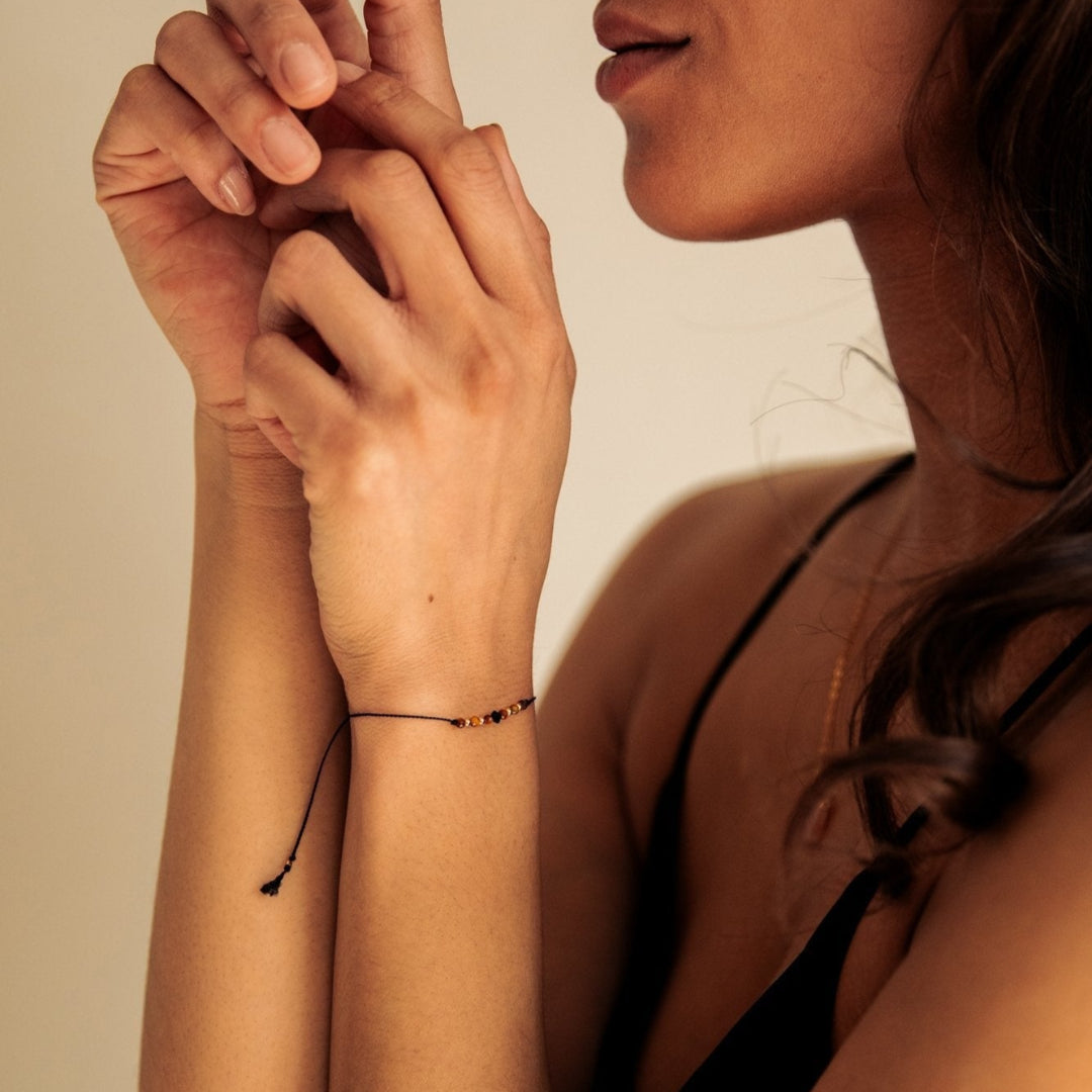 Woman wearing a black bikini with a neutral background