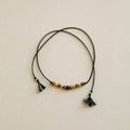 Necklace with beads and tassels on a beige background
