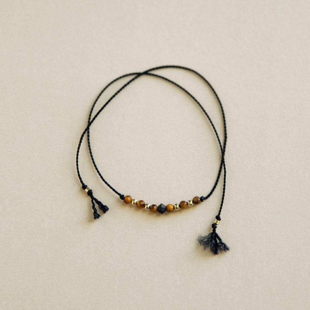 Necklace with beads and tassels on a beige background
