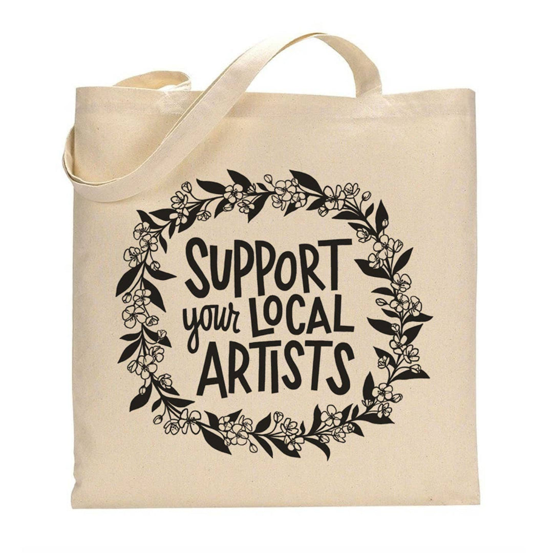 Beige tote bag with 'Support your local artists' text and floral design on a white background