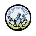 Embroidered patch with three pigeons and 'Wild in the Streets' text on a white background